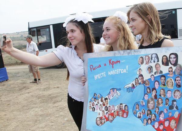 Las participantes del concurso de arte infantil hacen fotos con la fiscal de la república de Crimea Natalia Poklónskaya. - Sputnik Mundo