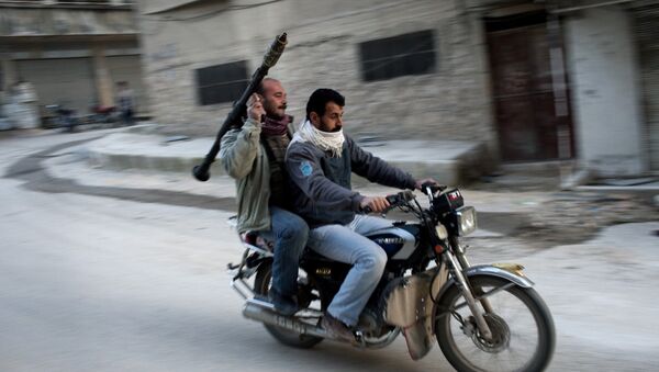 Supporters of the Free Syrian Army ride a motorcycle with a rocket-propelled grenade in Kafar Taharim, Syria. - Sputnik Mundo