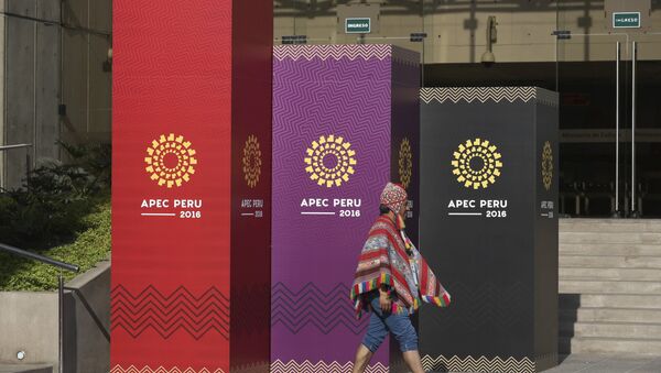 A man dressed in traditional Andean clothes walks past the logo of the APEC 2016 summit in Lima, Peru, Wednesday, Nov. 16, 2016. - Sputnik Mundo