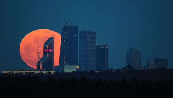 La luna llena detrás de los edificios del centro de negocios Moscow City - Sputnik Mundo