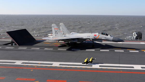 This picture taken on an undisclosed date in December 2016 shows a Chinese J-15 fighter jet preparing to take off from the deck of the Liaoning aircraft carrier - Sputnik Mundo
