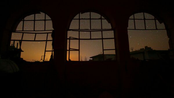 The night sky is seen through damaged windows in the rebel-controlled town of Binnish in Idlib province, Syria - Sputnik Mundo