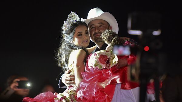 Rubi Ibarra and her father Cresencio Ibarra dance during the celebration of her 15th birthday in Villa Guadalupe, San Luis Potosi State, on December 26, 2016. Rubi, a small-town Mexican teen, welcomed thousands of guests for her 15th birthday party after her parents' video invitation to the milestone event went viral online. - Sputnik Mundo