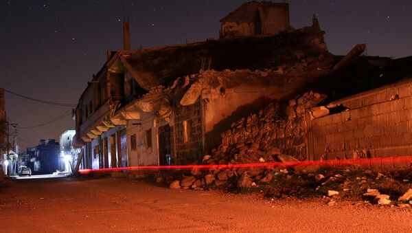Edificios dañados se ven por la noche en la ciudad rebelde de Dael - Sputnik Mundo
