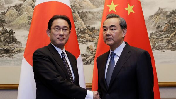 Ministro de Exteriores de Japón, Fumio Kishida, con su homólogo chino Wang Yi - Sputnik Mundo