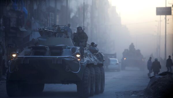 Russian soldiers, on armoured vehicles, patrol a street in Aleppo, Syria - Sputnik Mundo
