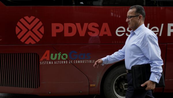 A man walks past a bus with the logo of Venezuelan oil company PDVSA in Caracas, Venezuela January 30, 2017 - Sputnik Mundo