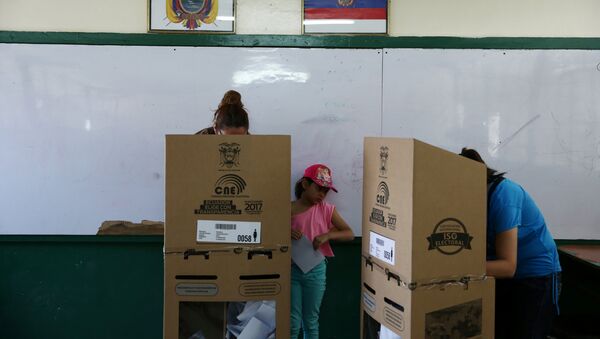 A girl looks on as women cast their votes during the presidential election at a school-turned-polling station in Quito, Ecuador - Sputnik Mundo