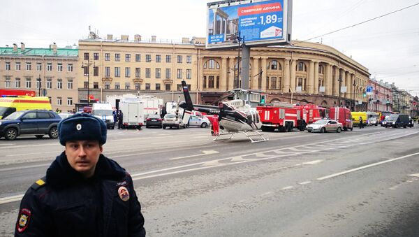 Emergency vehicles and a helicopter are seen at the entrance to Technological Institute metro station in Saint Petersburg on April 3, 2017 - Sputnik Mundo
