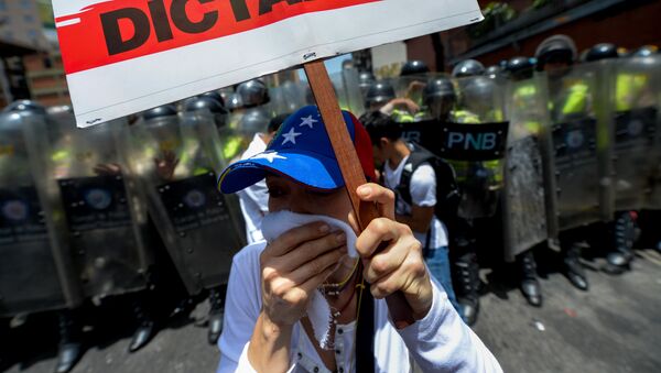 Opposition activists protest against President Nicolas Maduro's government in Caracas on April 4, 2017 - Sputnik Mundo