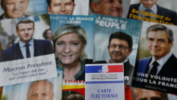A photo illustration shows a French voter card in front of pictures of the candidates for the French presidential election - Sputnik Mundo
