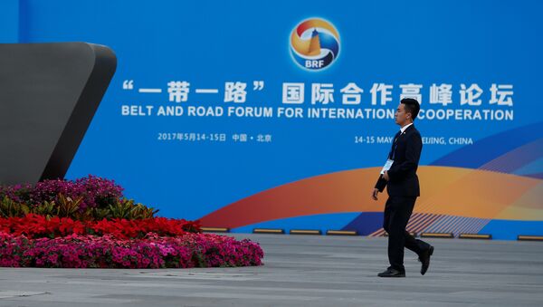 A man walks past the China National Convention Center, a venue of the upcoming Belt and Road Forum in Beijing, China, May 12, 2017 - Sputnik Mundo