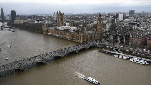 The Palace of Westminster, comprising the House of Commons and the House of Lords, wchich together make up the Houses of Parliament, are pictured on the banks of the River Thames alongside Westminster Bridge in central London on March 29, 2017 - Sputnik Mundo