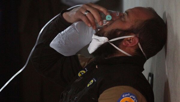 A civil defence member breathes through an oxygen mask, after what rescue workers described as a suspected gas attack in the town of Khan Sheikhoun in rebel-held Idlib, Syria April 4, 2017. - Sputnik Mundo