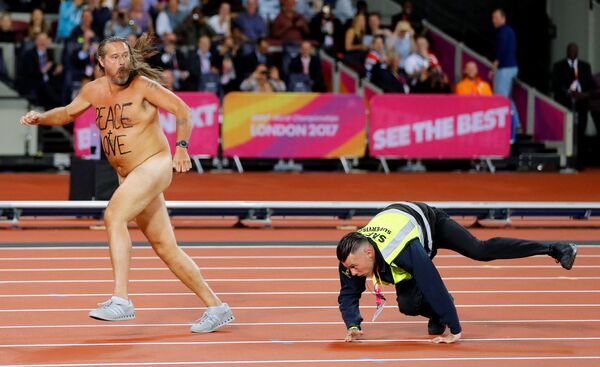 Un guardia persigue a un hombre desnudo que se coló en la pista durante el Campeonato Mundial de Atletismo de 2017 - Sputnik Mundo
