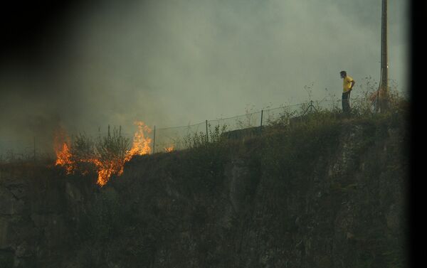 Una persona observa las llamas del fuego en Galicia - Sputnik Mundo