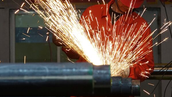 Un trabajador pule tubos de acero en una fábrica de Dongbei Special Steel Group en Dalian - Sputnik Mundo