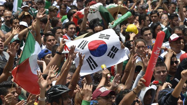 Hinchas mexicanos sostienen la bandera surcoreana en Ciudad de México - Sputnik Mundo