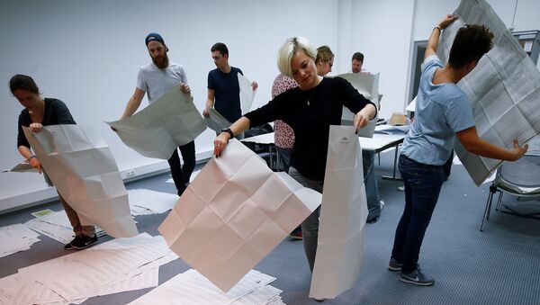Los funcionarios electorales clasifican las papeletas de votación después de la conclusión de la votación en las elecciones estatales de Baviera en Múnich, Alemania. - Sputnik Mundo