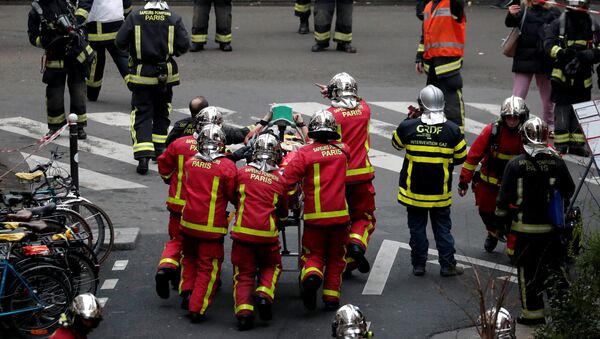 Los bomberos llevan a un herido en la explosión en París - Sputnik Mundo