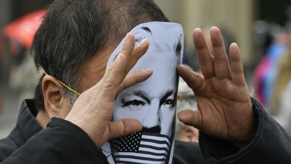 Activista con una máscara con el rostro de Julian Assange - Sputnik Mundo