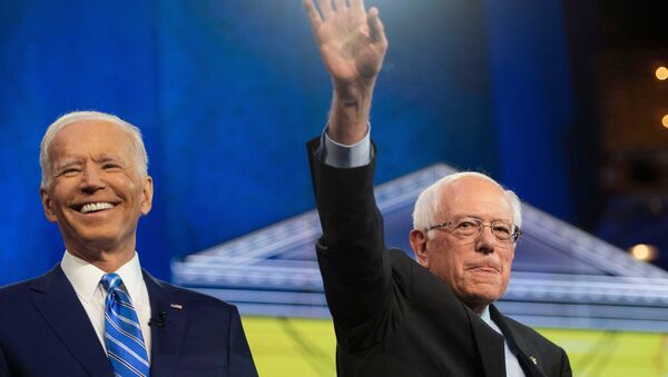 Democratic presidential primary candidates Vice President Joe Biden and Sen. Bernie Sanders greet the audience from the debate stage Thursday, June 27, 2019, at the Adrienne Arsht Center for the Performing Arts in Miami. Tcn Debate - Sputnik Mundo