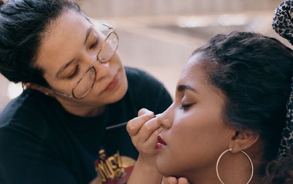 Ivette Dominguez maquillando a una joven - Sputnik Mundo