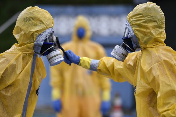 Personal médico vestido con trajes protectores reciben instrucciones sobre la pandemia del coronavirus en Brasil. - Sputnik Mundo