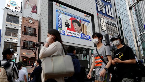 La imagen del primer ministro japonés Shinzo Abe en una pantalla en Tokio - Sputnik Mundo