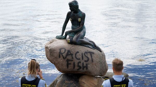 La estatua de la Sirenita en Copenhague con el lema de pez racista  - Sputnik Mundo