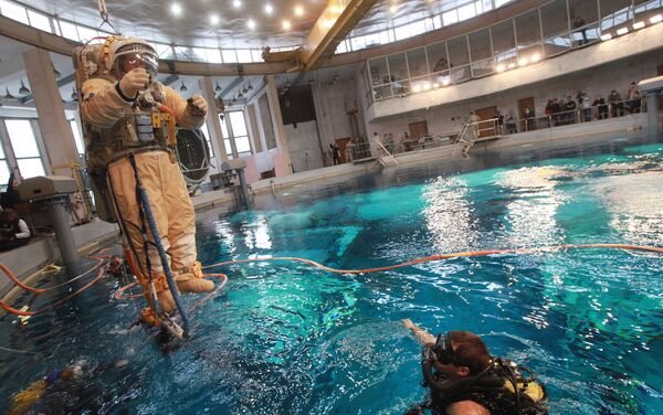 Un cosmonauta es alzado por una grúa antes de sumergirse en la 'piscina cósmica' del Centro Gagarin (2010) - Sputnik Mundo