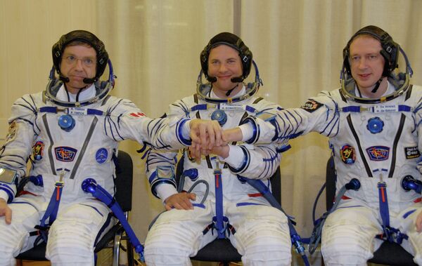 La tripulación de la nave Soyuz TMA-15 (de la izquierda a la derecha): Robert Thirsk, Román Romanenko y Frank De Winne. - Sputnik Mundo
