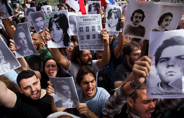 Manifestantes sostienen imágenes de los desaparecidos durante el periodo dictatorial en Brasil - Sputnik Mundo